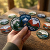Hand Holding Appalachian Pacific Crest And Zion Adventure Badges