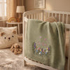 Knitted Baby Blanket Draped Over Crib